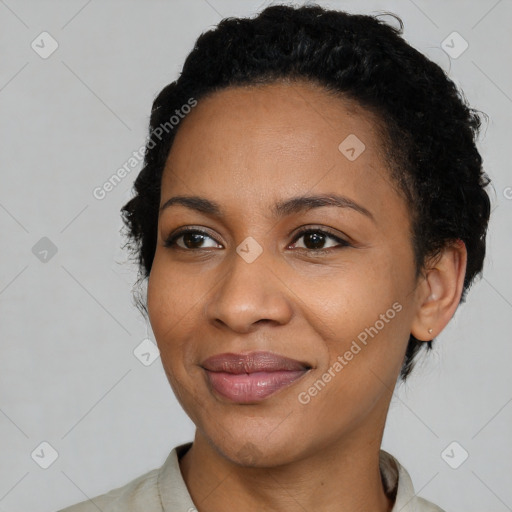 Joyful black young-adult female with short  black hair and brown eyes