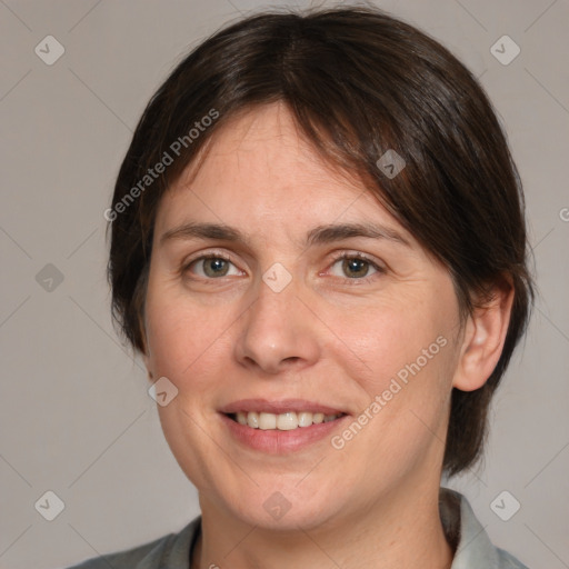 Joyful white adult female with medium  brown hair and brown eyes