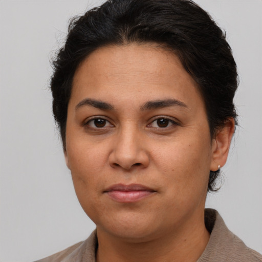 Joyful latino young-adult female with short  brown hair and brown eyes
