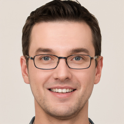 Joyful white young-adult male with short  brown hair and grey eyes