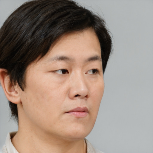 Neutral asian young-adult male with short  brown hair and brown eyes