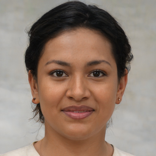 Joyful latino young-adult female with short  brown hair and brown eyes