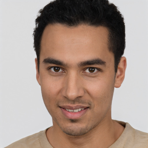 Joyful white young-adult male with short  black hair and brown eyes