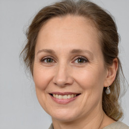 Joyful white adult female with medium  brown hair and brown eyes