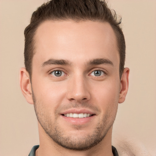 Joyful white young-adult male with short  brown hair and brown eyes