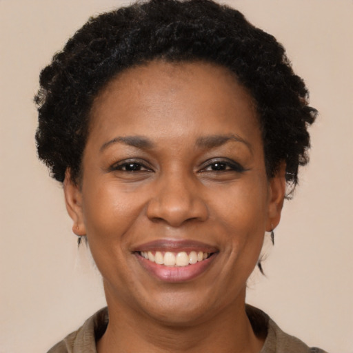 Joyful black adult female with short  brown hair and brown eyes