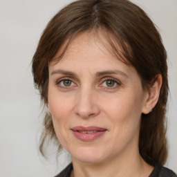 Joyful white adult female with medium  brown hair and grey eyes