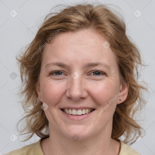 Joyful white adult female with medium  brown hair and blue eyes