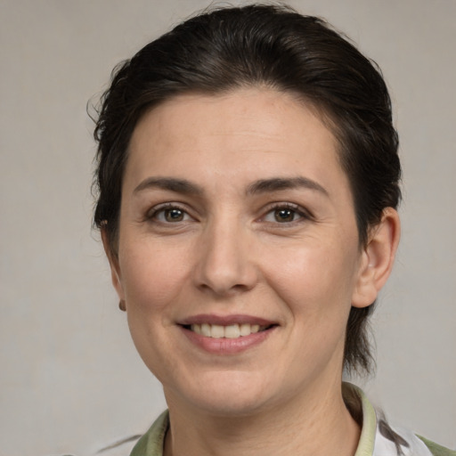 Joyful white adult female with medium  brown hair and brown eyes