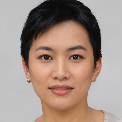 Joyful asian young-adult female with short  black hair and brown eyes