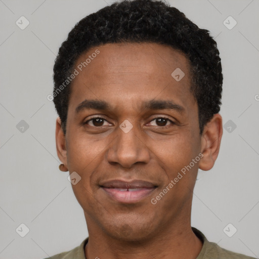 Joyful black adult male with short  black hair and brown eyes