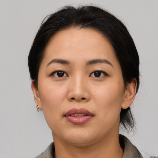 Joyful asian young-adult female with medium  black hair and brown eyes