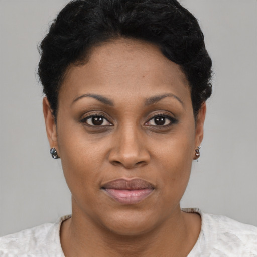 Joyful black young-adult female with short  brown hair and brown eyes