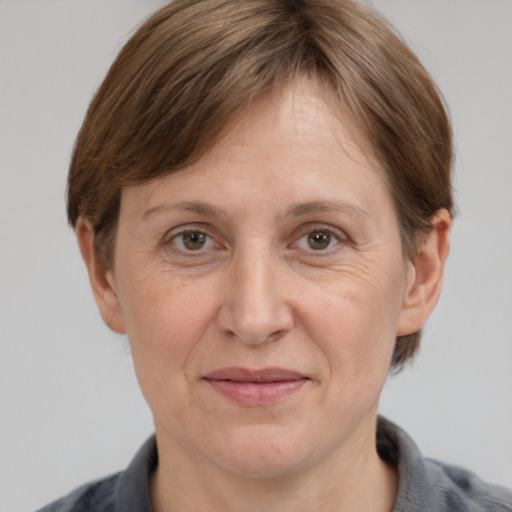 Joyful white adult female with medium  brown hair and grey eyes