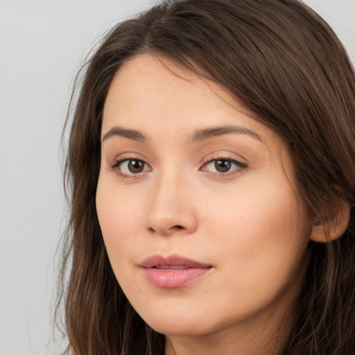 Neutral white young-adult female with long  brown hair and brown eyes