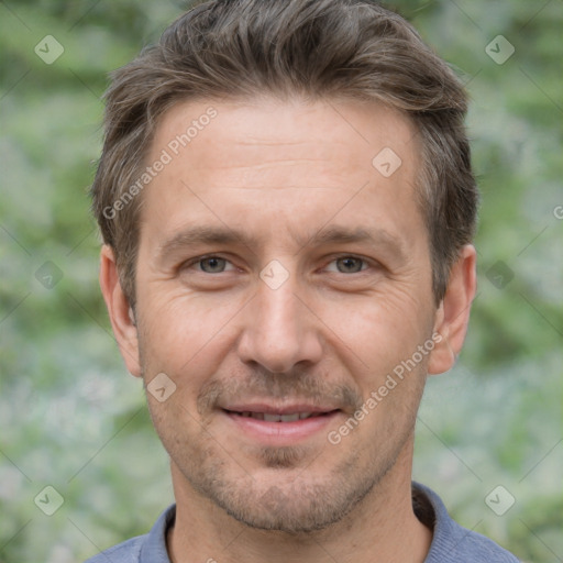 Joyful white adult male with short  brown hair and brown eyes