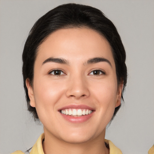 Joyful white young-adult female with medium  black hair and brown eyes