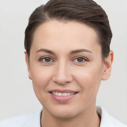 Joyful white young-adult female with short  brown hair and brown eyes