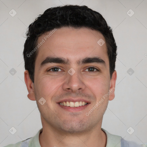 Joyful white young-adult male with short  black hair and brown eyes