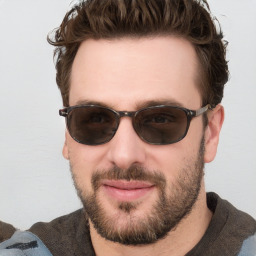 Joyful white young-adult male with short  brown hair and blue eyes