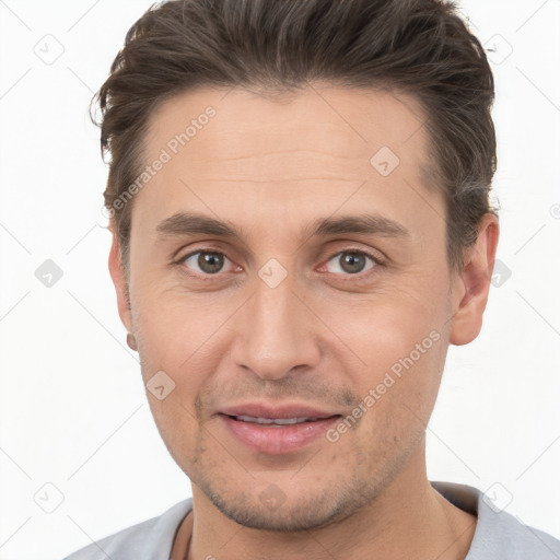 Joyful white young-adult male with short  brown hair and brown eyes