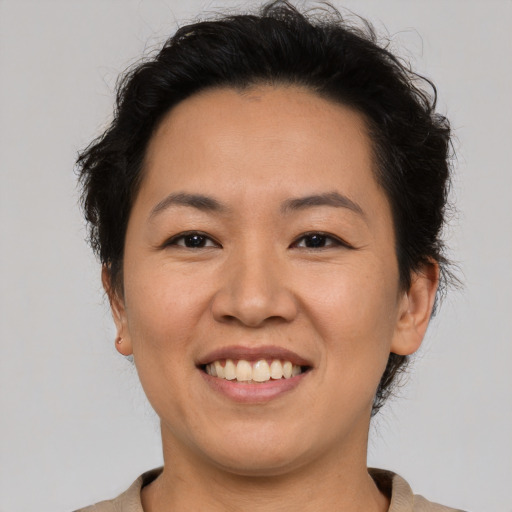Joyful asian young-adult female with short  brown hair and brown eyes