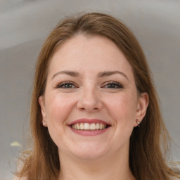 Joyful white young-adult female with long  brown hair and grey eyes