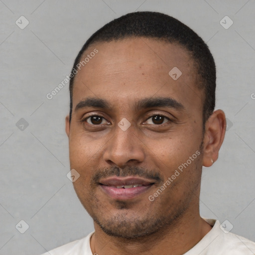 Joyful latino young-adult male with short  black hair and brown eyes