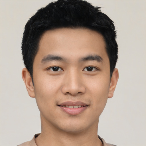 Joyful asian young-adult male with short  black hair and brown eyes