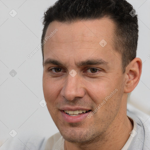 Joyful white adult male with short  brown hair and brown eyes