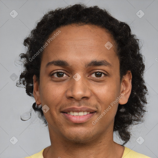 Joyful black young-adult male with short  brown hair and brown eyes