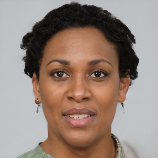 Joyful black adult female with short  brown hair and brown eyes