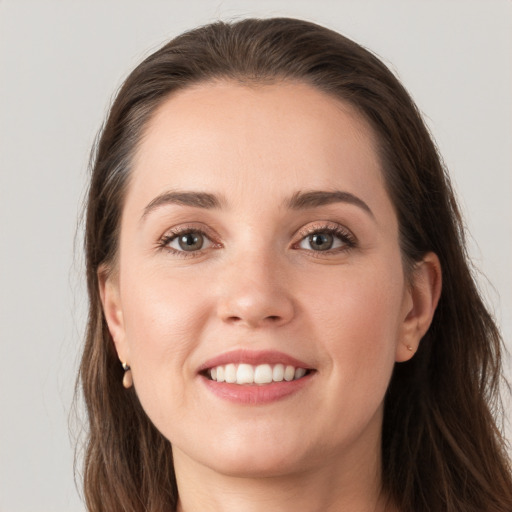 Joyful white young-adult female with long  brown hair and grey eyes