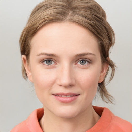 Joyful white young-adult female with medium  brown hair and blue eyes