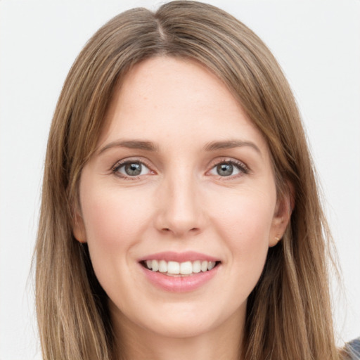 Joyful white young-adult female with long  brown hair and grey eyes