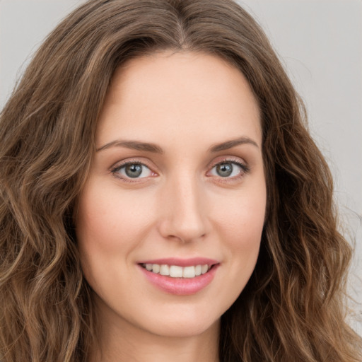 Joyful white young-adult female with long  brown hair and green eyes