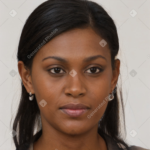 Joyful black young-adult female with long  brown hair and brown eyes
