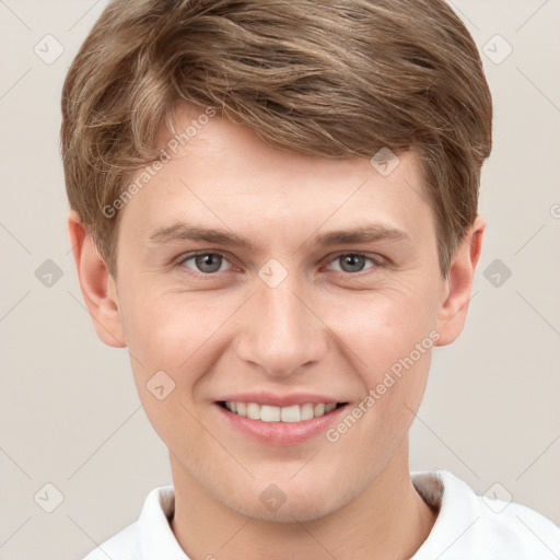 Joyful white young-adult male with short  brown hair and grey eyes