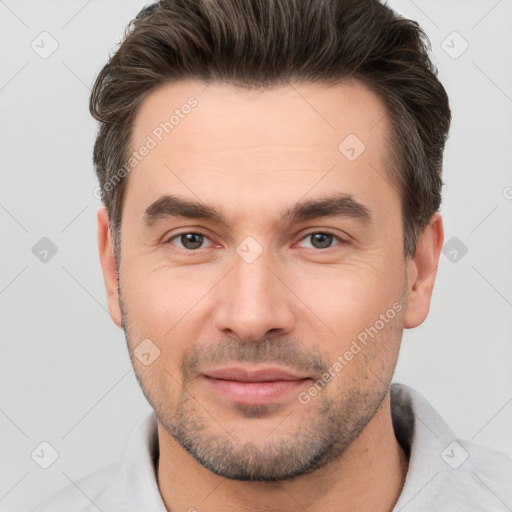 Joyful white adult male with short  brown hair and brown eyes