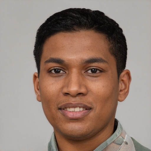 Joyful latino young-adult male with short  black hair and brown eyes