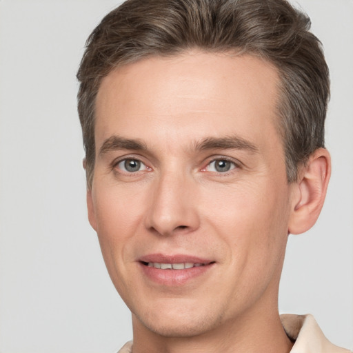 Joyful white adult male with short  brown hair and brown eyes