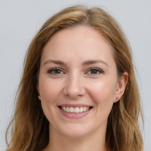 Joyful white young-adult female with long  brown hair and grey eyes