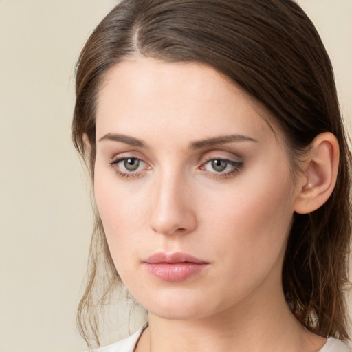 Neutral white young-adult female with medium  brown hair and green eyes