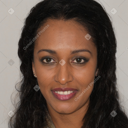 Joyful black young-adult female with long  brown hair and brown eyes