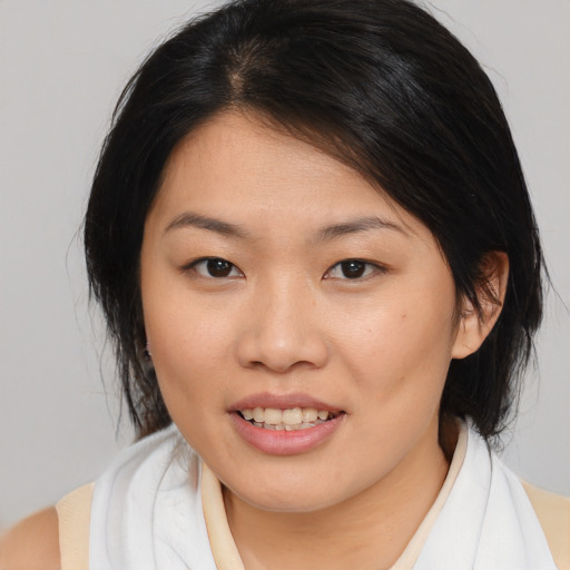 Joyful asian young-adult female with medium  brown hair and brown eyes