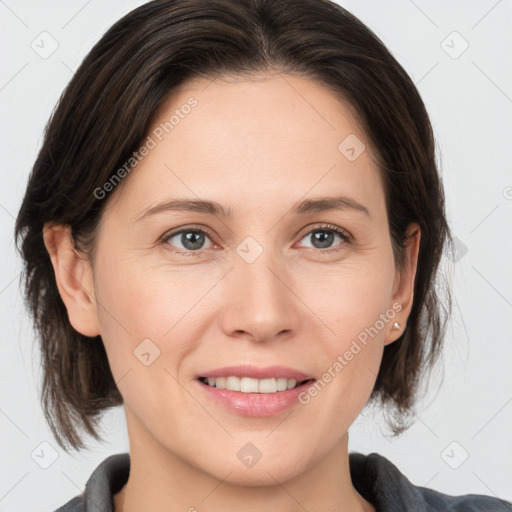 Joyful white adult female with medium  brown hair and grey eyes