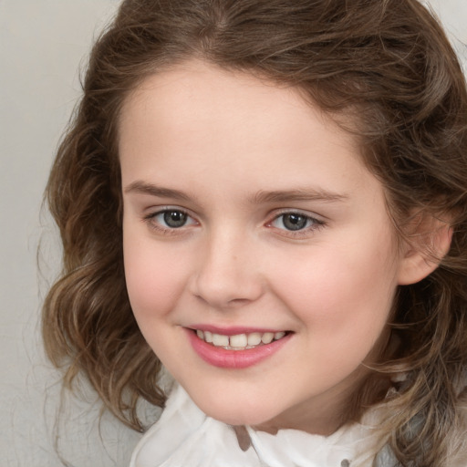 Joyful white child female with medium  brown hair and brown eyes