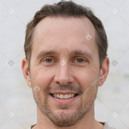 Joyful white adult male with short  brown hair and grey eyes