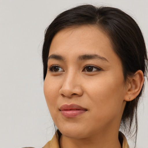 Joyful asian young-adult female with long  brown hair and brown eyes