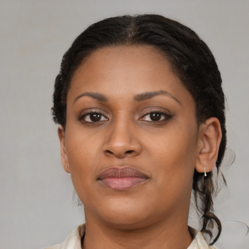 Joyful black young-adult female with medium  brown hair and brown eyes